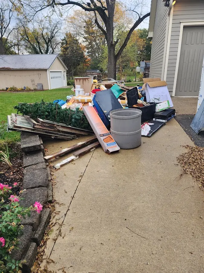 Dumpster being loaded with debris for 12 Yard Dumpster Rental in Port Lavaca